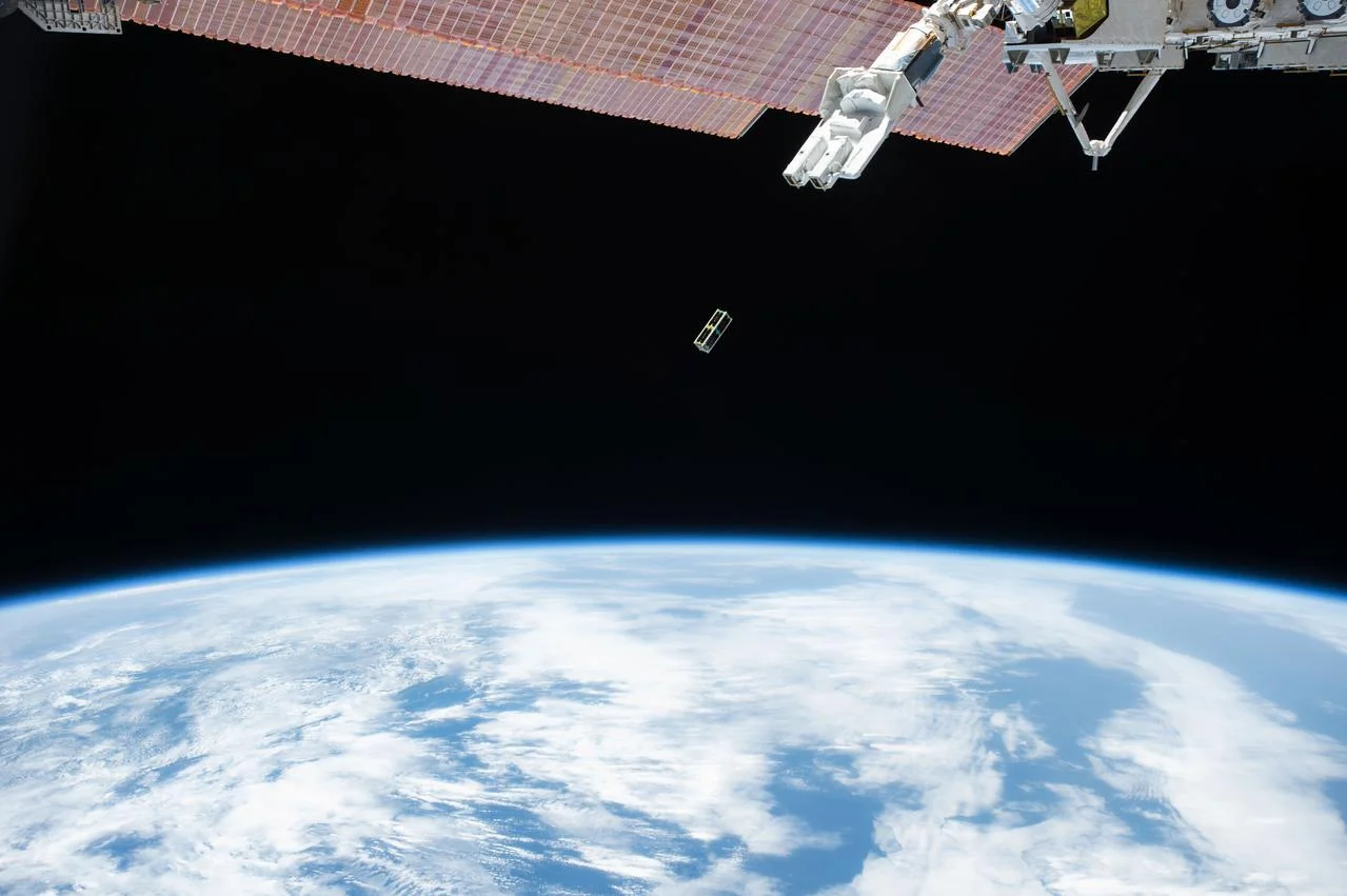 A small satellite deployed from the International Space Station above Earth